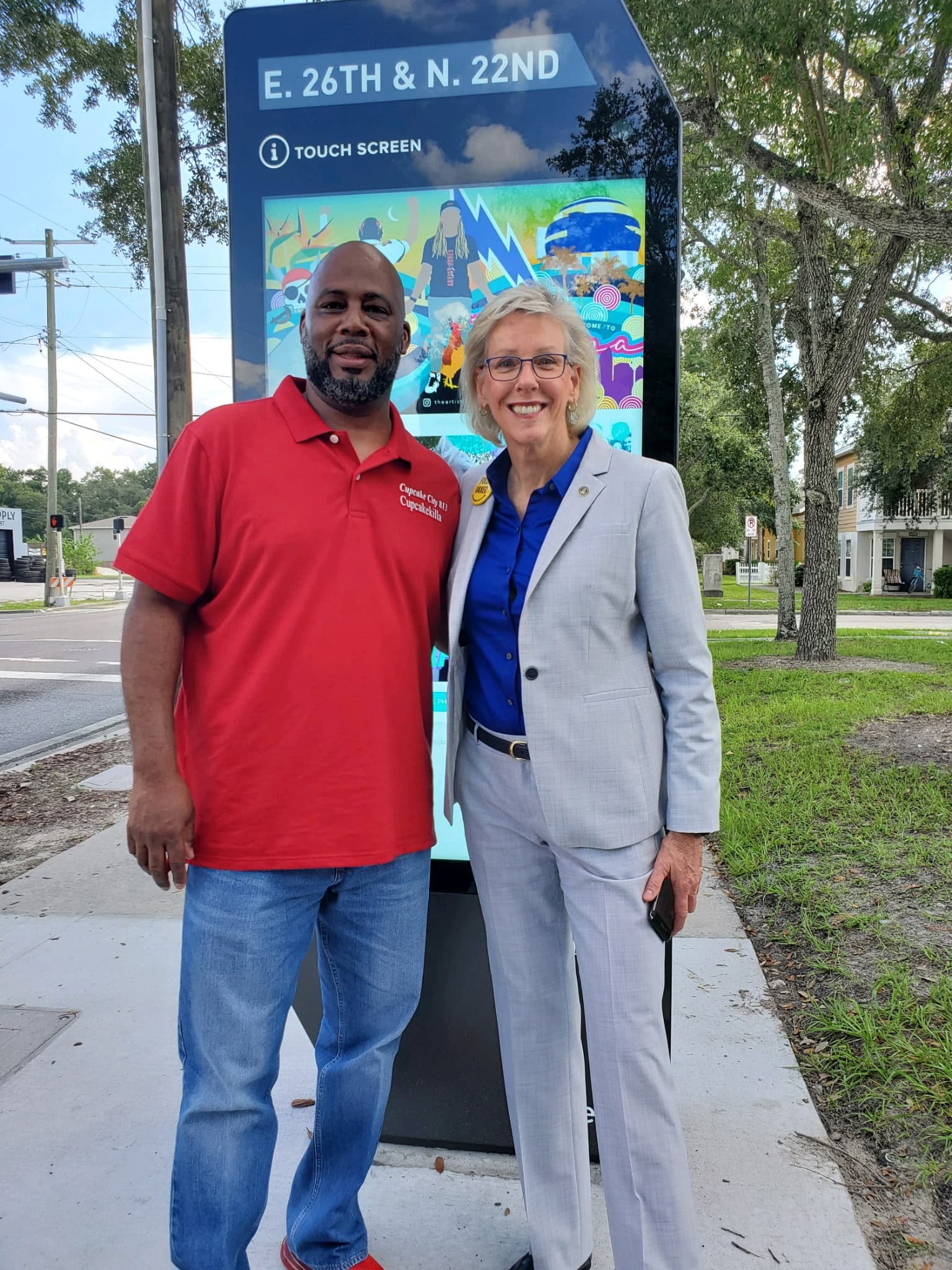 Chef Alvin and Tampa Mayor Jane Castor standing together in front of a City of Tampa smart kiosk