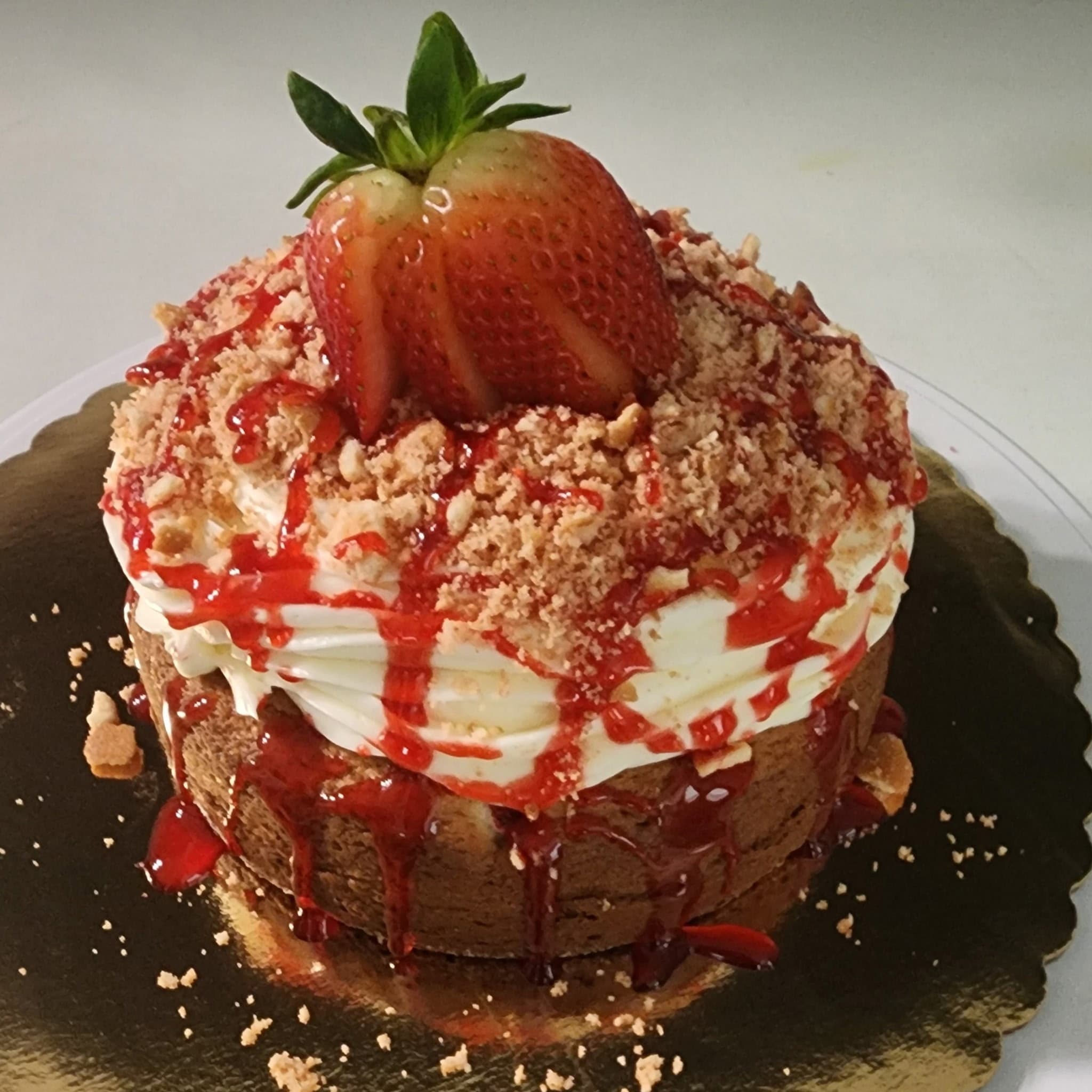 Strawberry crunch cake topped with a fresh strawberry from Cupcake City 813 in Tampa